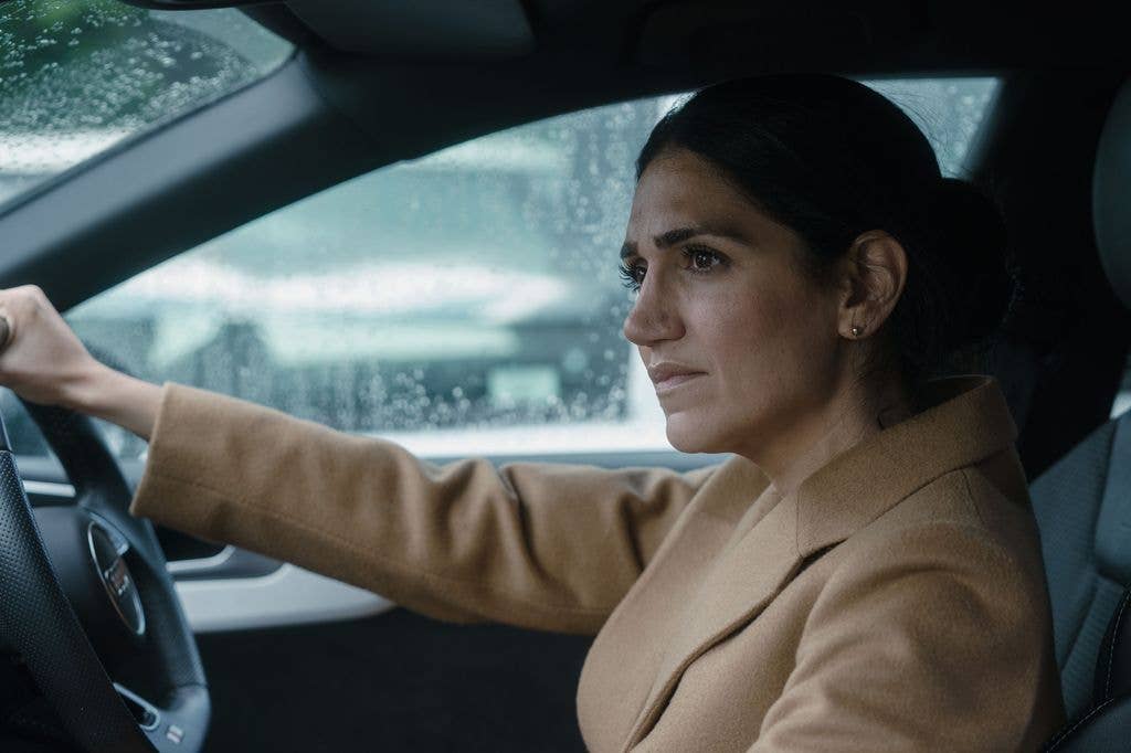 Leila Farzad driving a car in a still image from Better