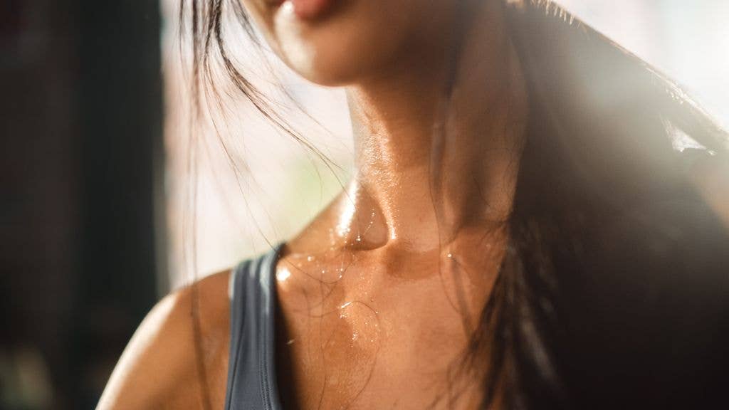 Close up Shot of a Young Adult woman's neck Sweating After Heavy Workout at Home. 