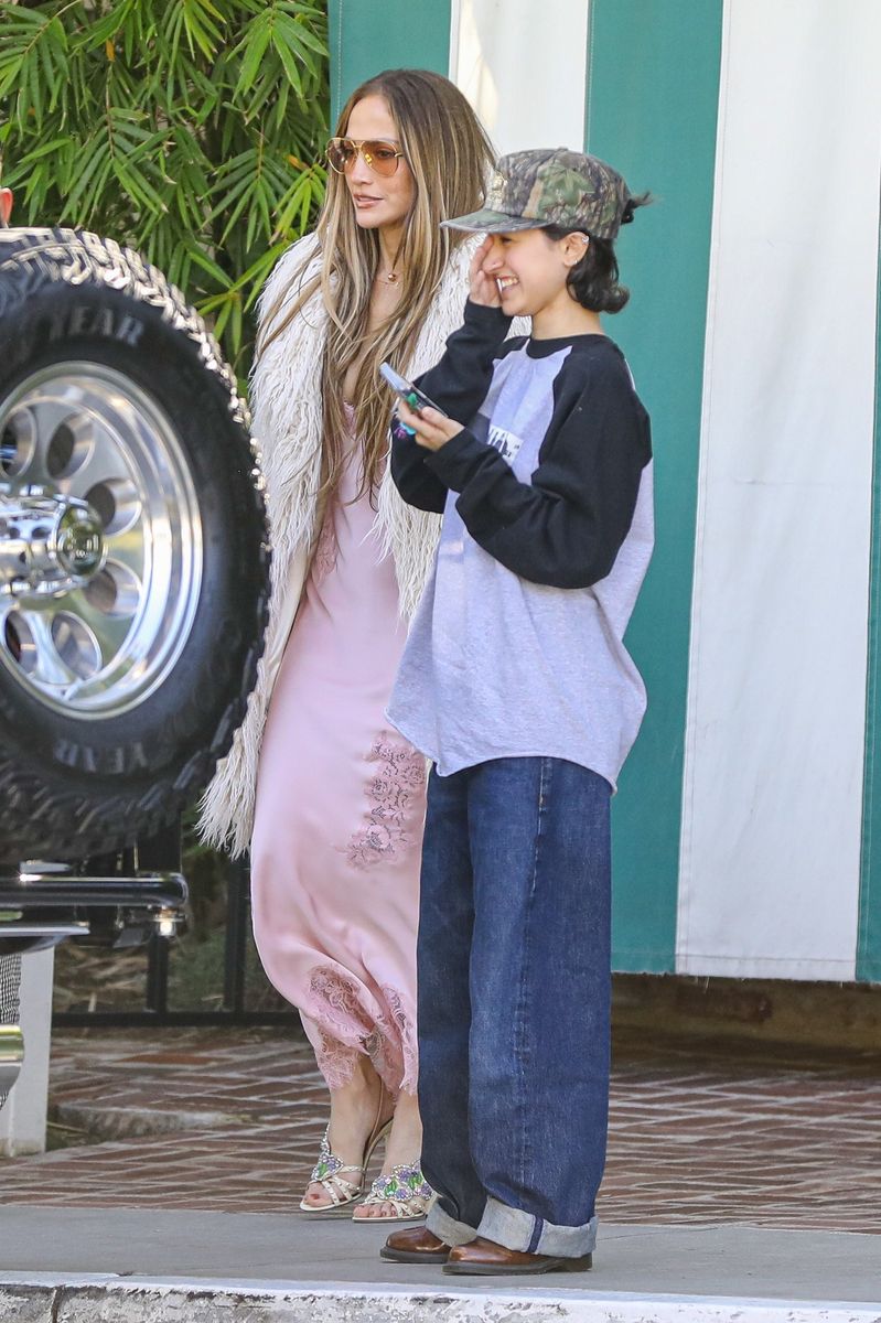 For the occasion JLo embraced romantic sophistication in a blush pink slip dress featuring a plunging V-neckline and delicate lace trim. 