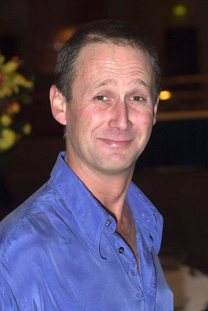 Clay Hogan wars a bright blue shirt and smiles at the camera.