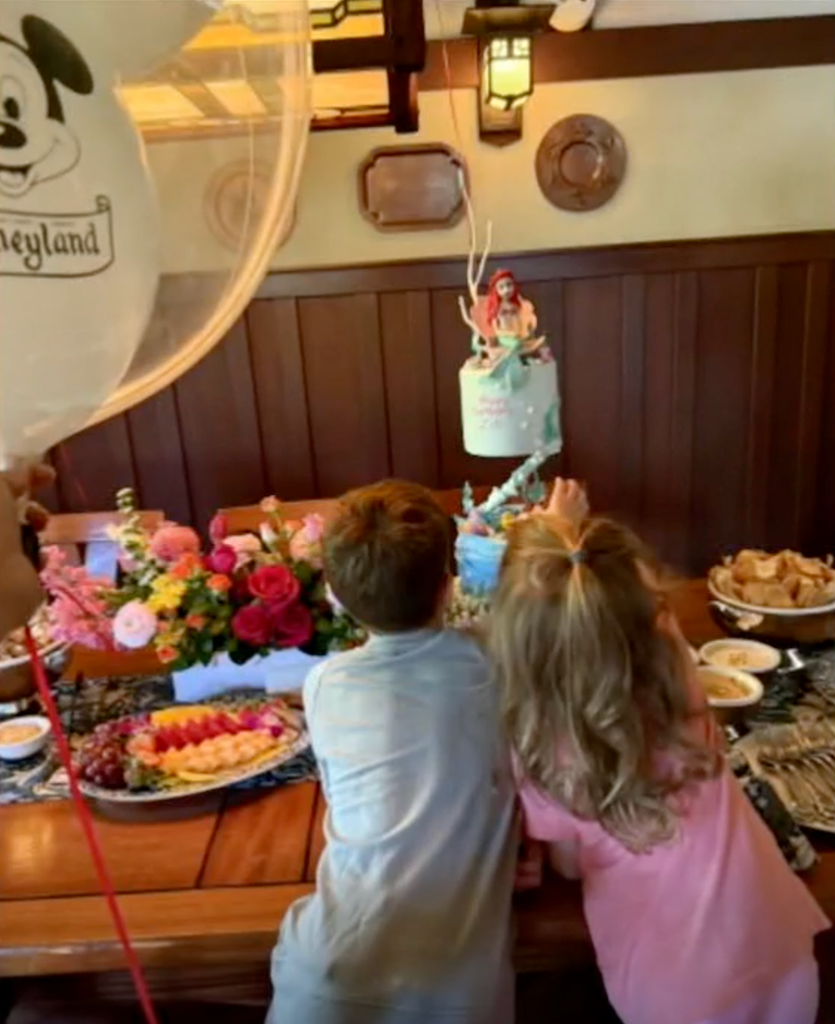 Archie and Lilibet looking at Lilibet's Little Mermaid-themed cake on Lilibet's  4th birthday