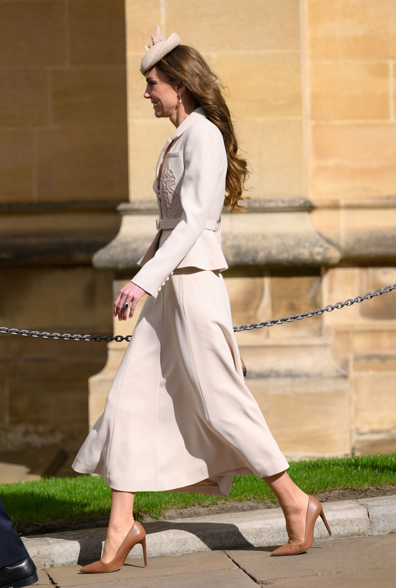 Kate Middleton walking into Easter service in white outfit symbolizing renewal