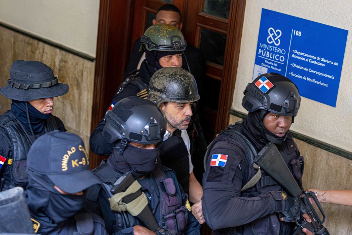 Members of special police forces take businessman Antonio Espaillat into custody in Santo Domingo on June 15, 2025. Prosecutors in the Dominican Republic said on June 12 they had arrested the owners of a nightclub that collapsed in April, killing 236 revelers, on manslaughter charges. Antonio Espaillat and his sister Maribel Espaillat were arrested over the collapse of the roof of the Jet Set club in the early hours of April 8 during a concert by merengue star Rubby Perez. (Photo by AFP) (Photo by STR/AFP via Getty Images)          