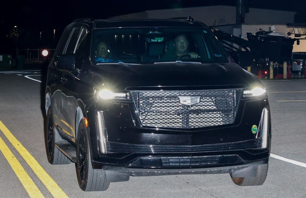 Tiger Woods is escorted out of the Martin County jail after being arrested for driving under the influence following the traffic accident.