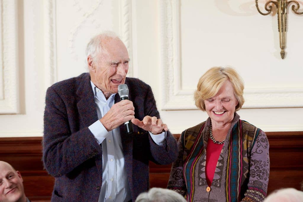 Peter Snow and Ann MacMillan laughing at a dinner