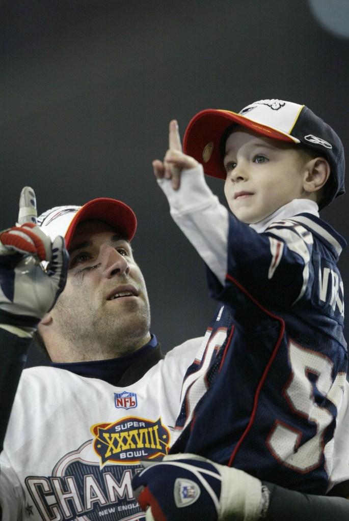 UNITED STATES - FEBRUARY 01:  Football: Super Bowl XXXVIII, Closeup of New England Patriots Mike Vrabel and son Tyler victorious after game vs Carolina Panthers, Houston, TX 2/1/2004  (Photo by John Biever/Sports Illustrated via Getty Images)  (SetNumber: X70032 TK4 R7 F20)