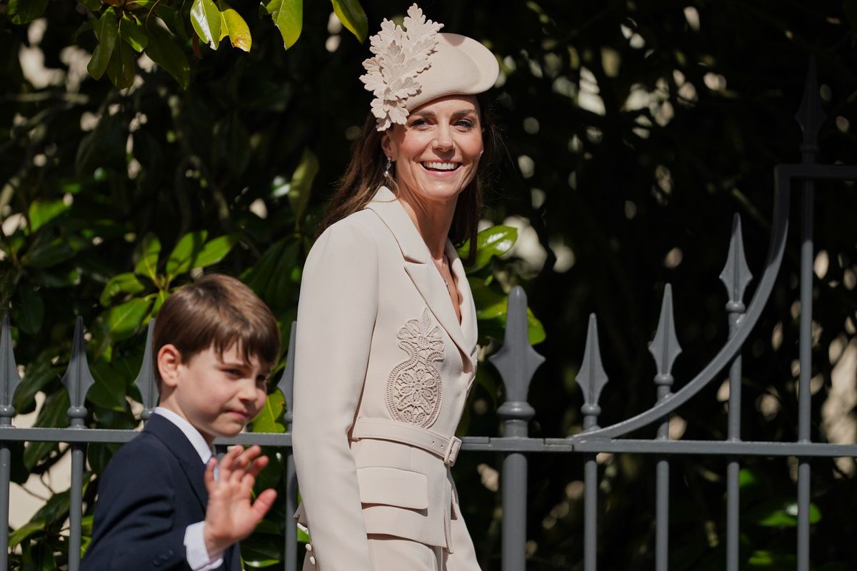 Kate Middleton walking into Easter service in white outfit symbolizing renewal