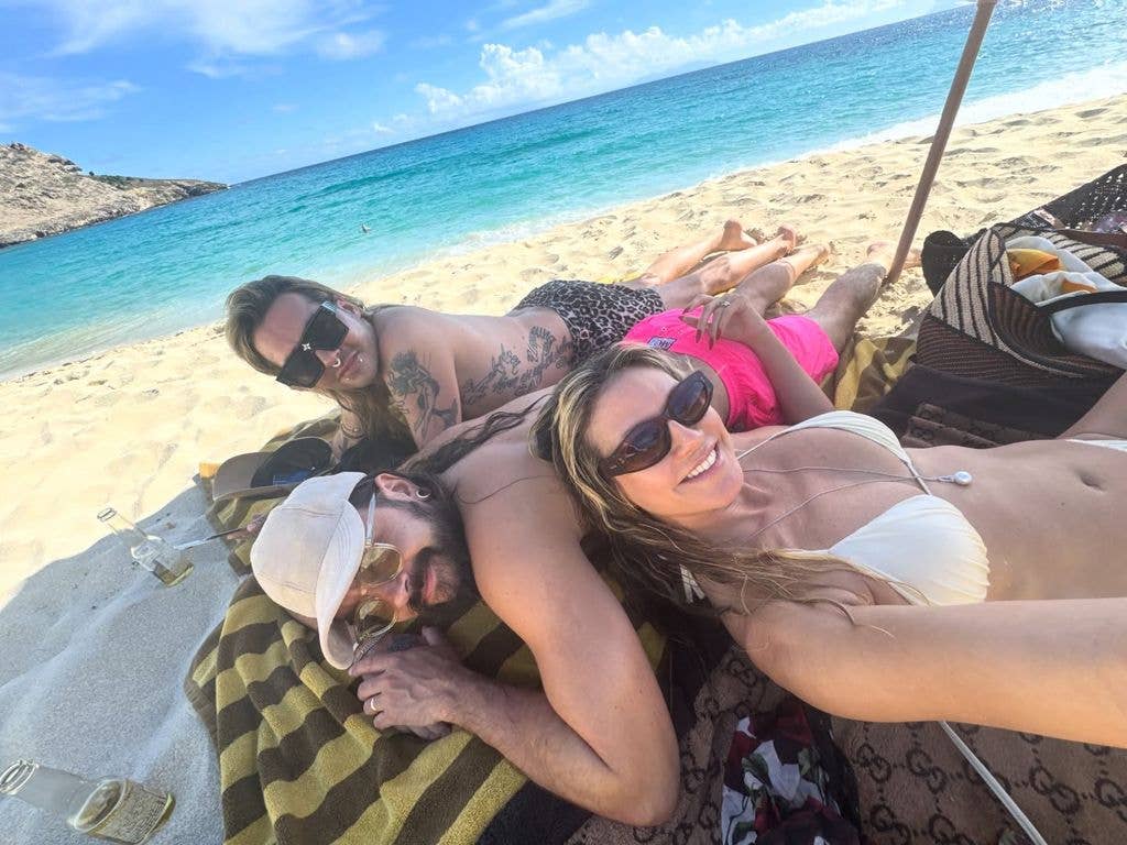 heidi klum with two people selfie lying down on beach