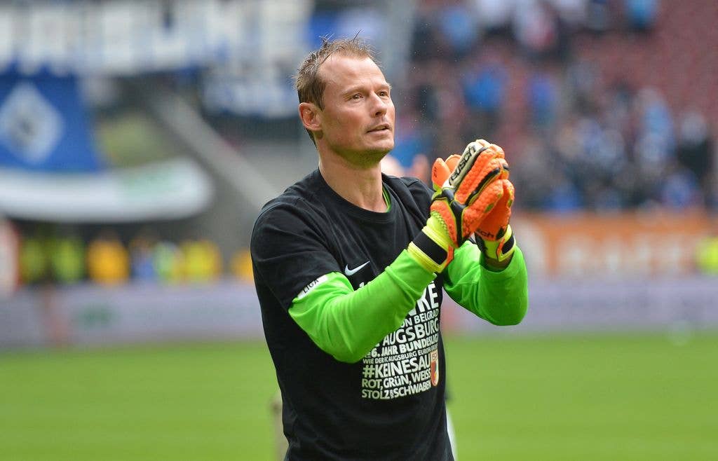 Alexander Manninger, goalkeeper of Augsburg celebrates with the fans after the Bundesliga match between FC Augsburg and Hamburger SV at SGL Arena on May 14, 2016 in Augsburg, Germany