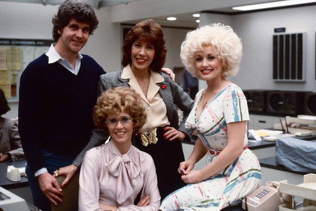 Portrait of, from left, Australian-American film director Colin Higgins (1941 - 1988), and American actors Jane Fonda (fore), Lily Tomlin (in checked blazer), and Dolly Parton on the set of the film '9 to 5' (also known as 'Nine to Five,' directed Higgins), Los Angeles, California, 1979.