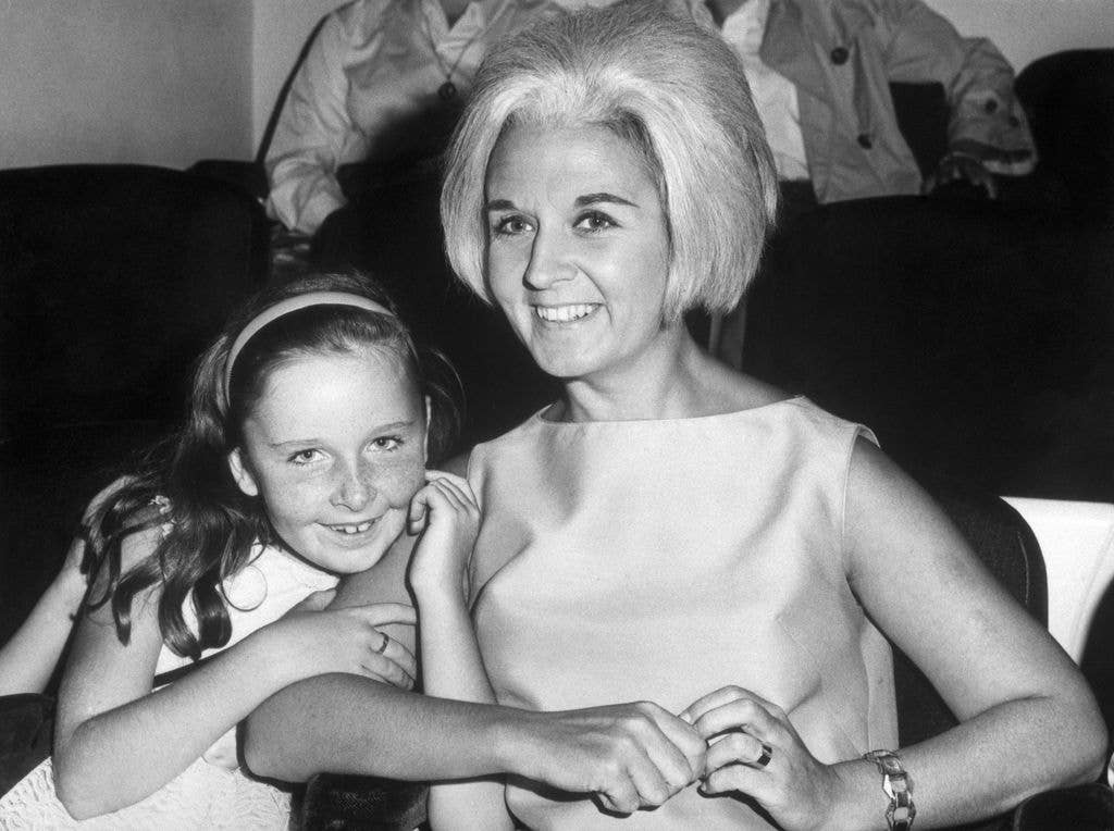 9/15/1965-New York, NY-Sybil Burton sits with her daughter Kate at a New York showing of the Beatles' most recent film "Help!" The occasion is the seventh birthday of the freckled daughter of Sybil and Richard Burton.