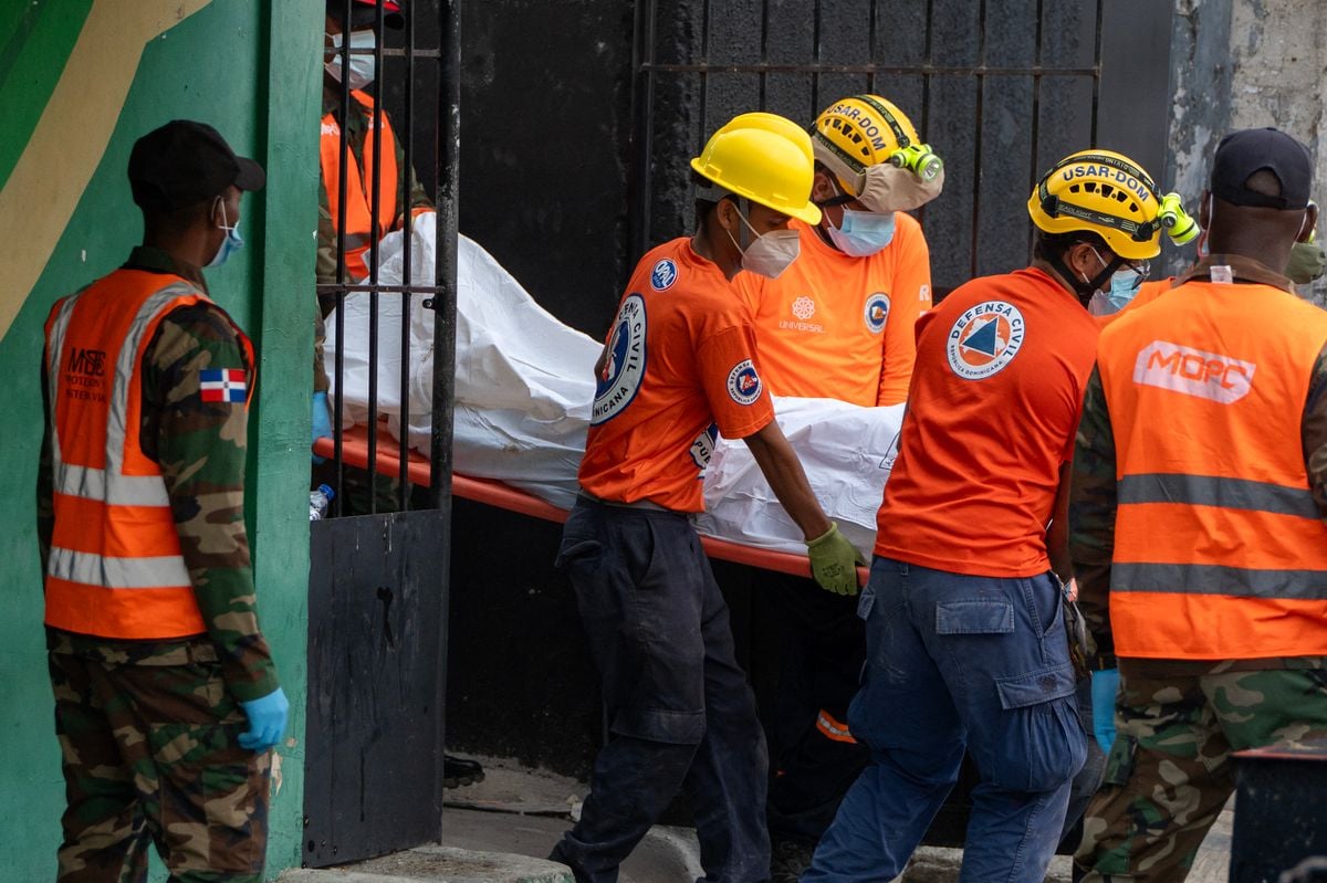 Rescue teams members carry the body of a victim from the Jet Set nightclub a day after the collapse of its roof in Santo Domingo.