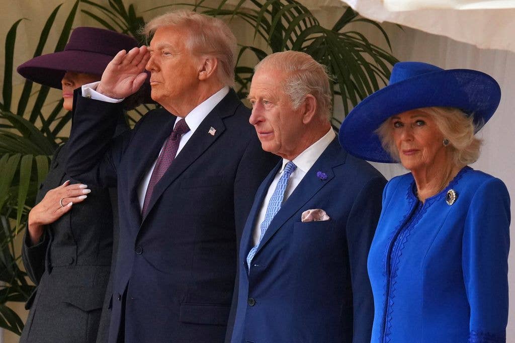 President Donald Trump salutes as he stands beside King Charles and Queen Camilla 