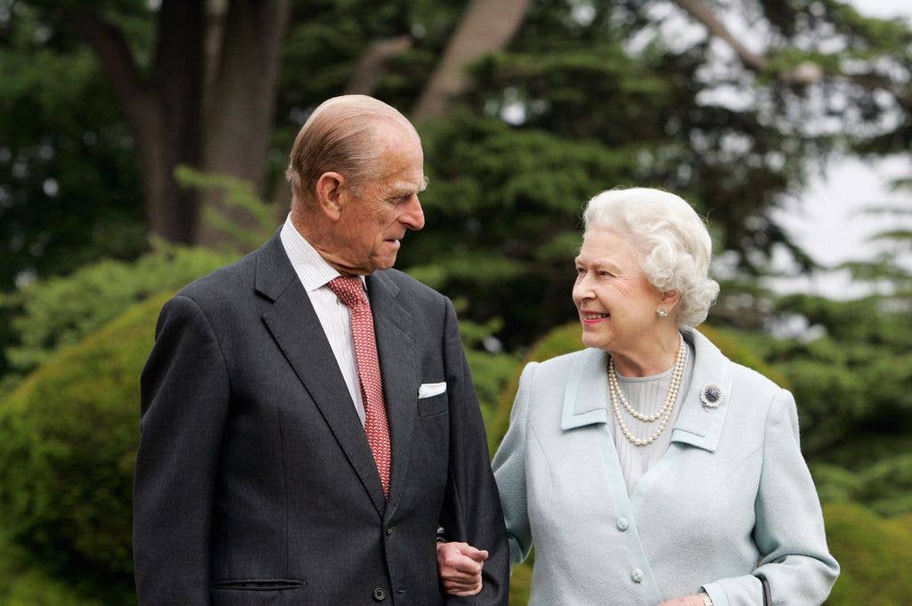 HM The Queen Elizabeth II and Prince Philip smiling at eachother