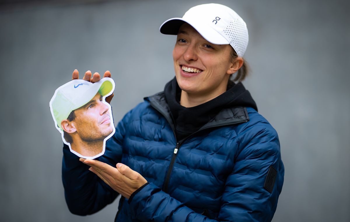 Iga holds a cutout of Raael during a photo shoot during media day at the Porsche Tennis Grand Prix Stuttgart 2023