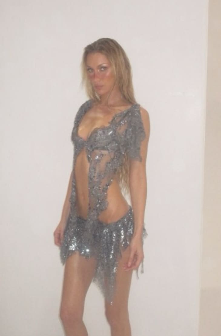 The interplay of transparency and embellishment accentuates her figure while maintaining a sleek, futuristic edge, embodying her signature take on “naked dressing” with a polished, editorial finish.