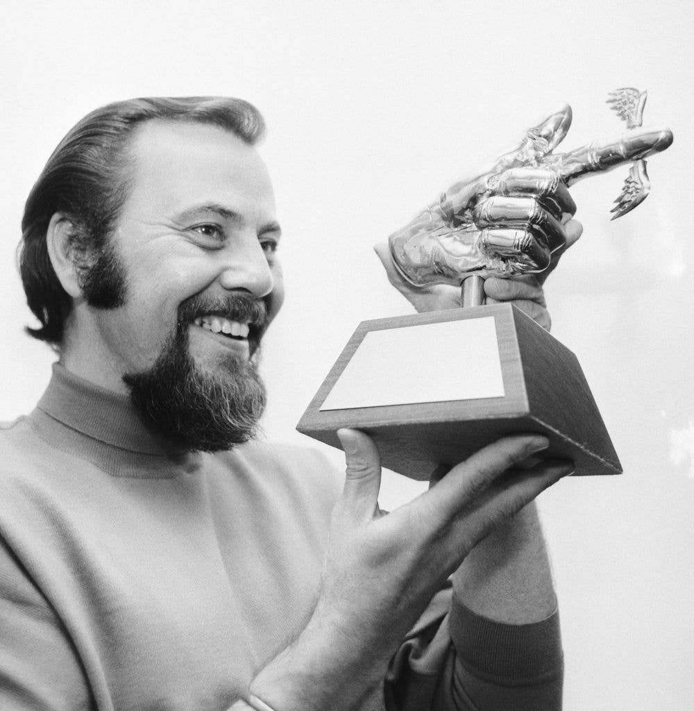 Hollywood: They call him Crazy George Schlatter on The Rowan and Martin Laugh-In, because no sane man could produce such madness every week. Here, George holds the well knows Flying Fickle Finger of Fate Award, one of the more popular attractions with Crazy George, on his Laugh-In show. The award is made sporadically whenever Schlatter discovers what he considers "a gigantic stupidity". Generally, selections for the award come from obscure notes in the news, colossal blunders by people in high places, bungling politicians or simply guys who goof on a grand scale. Schlatter maintains that the award is given gently in a light, funny way and that "nobody gets angry".