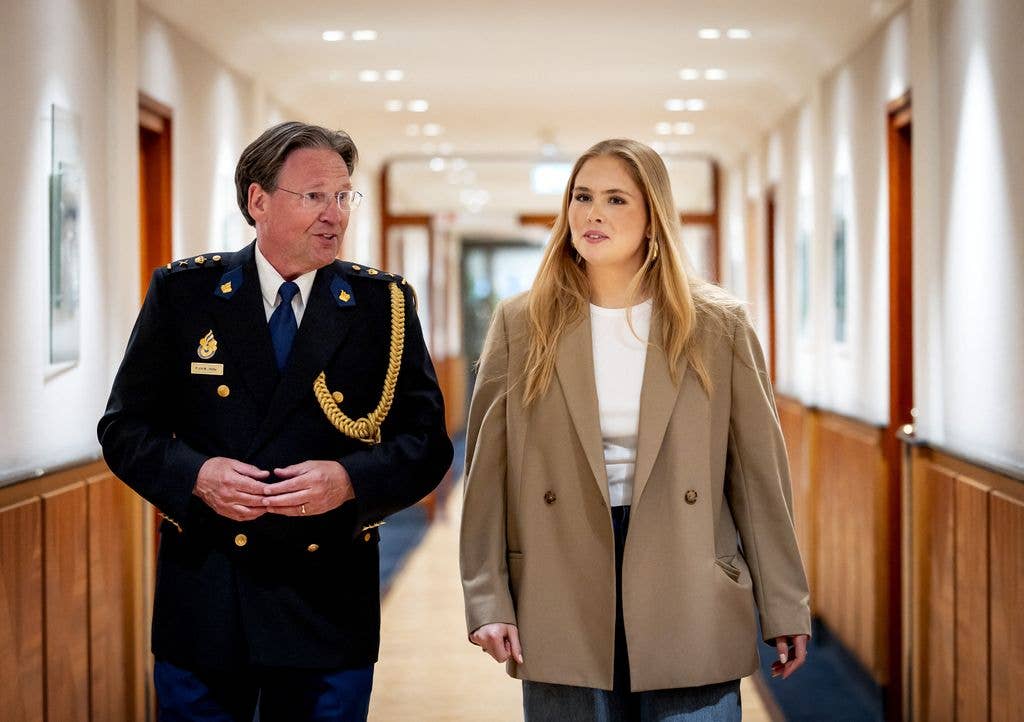 Princess Amalia walking through corridor with police chief