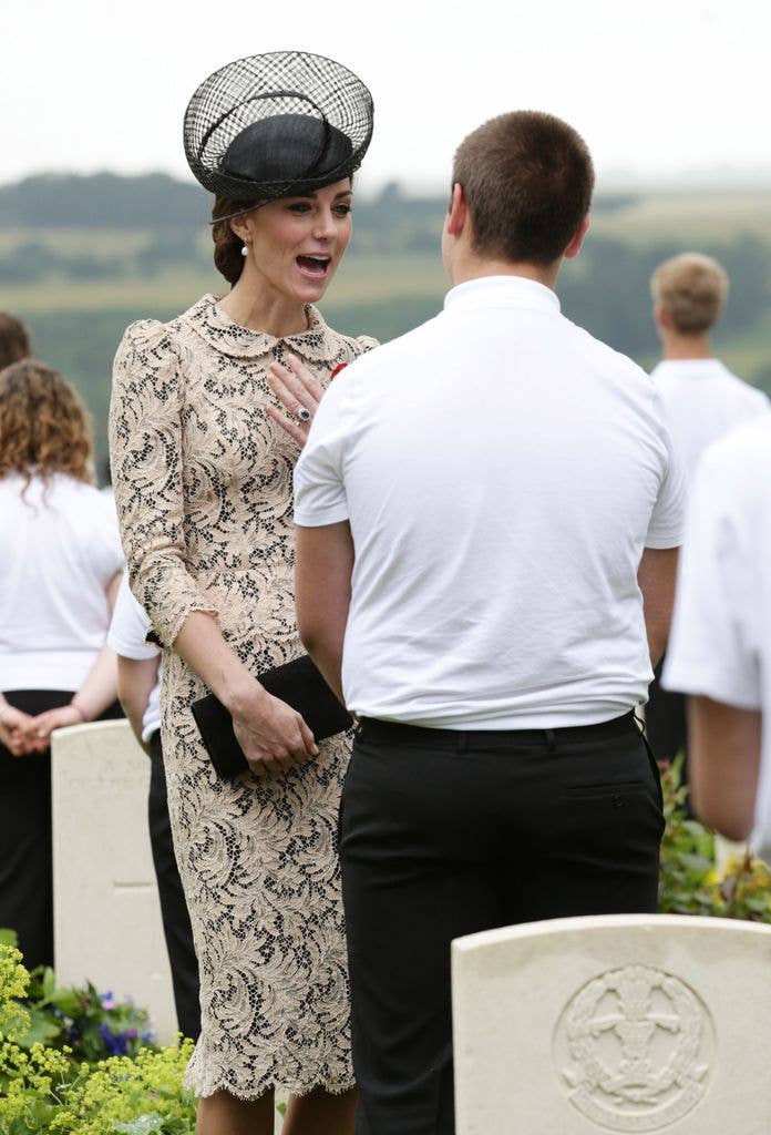 Catherine in lace dress talking to teenager