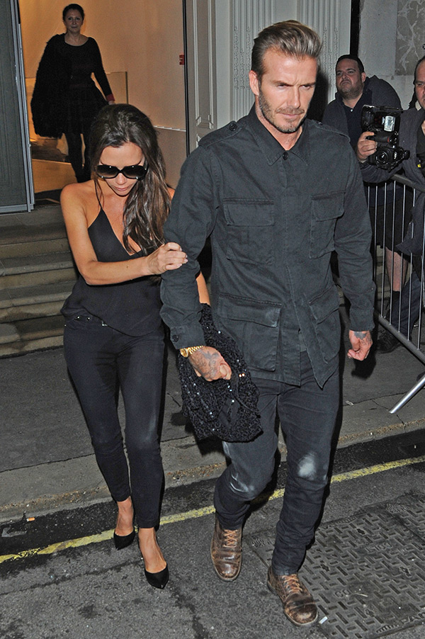 Victoria Beckham holds onto her husband