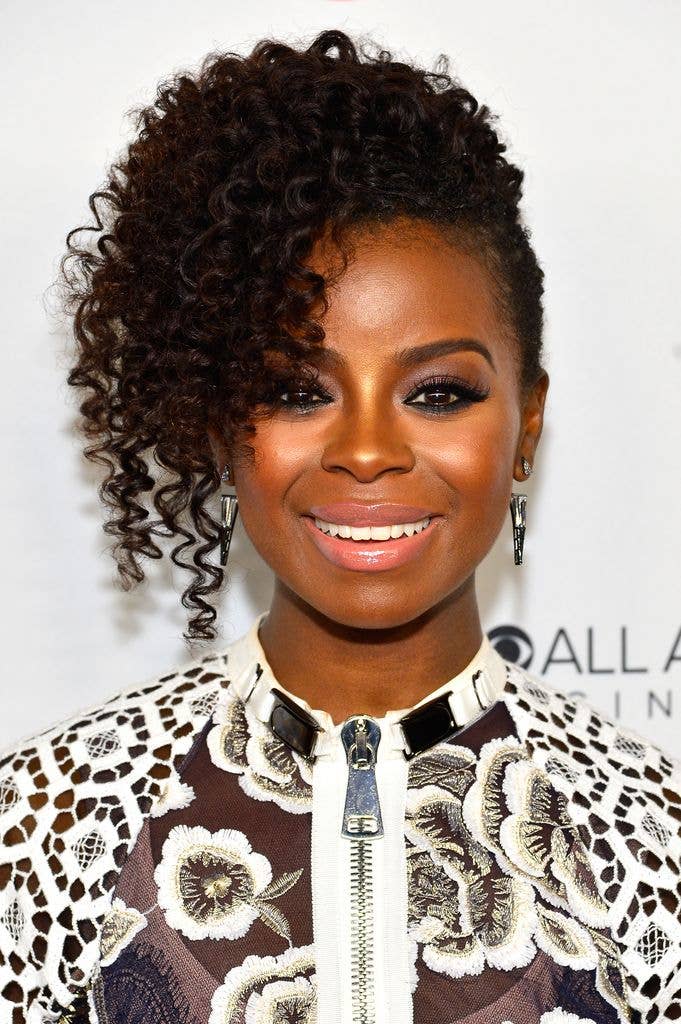 Erica Tazel smiling with curly hair at an event