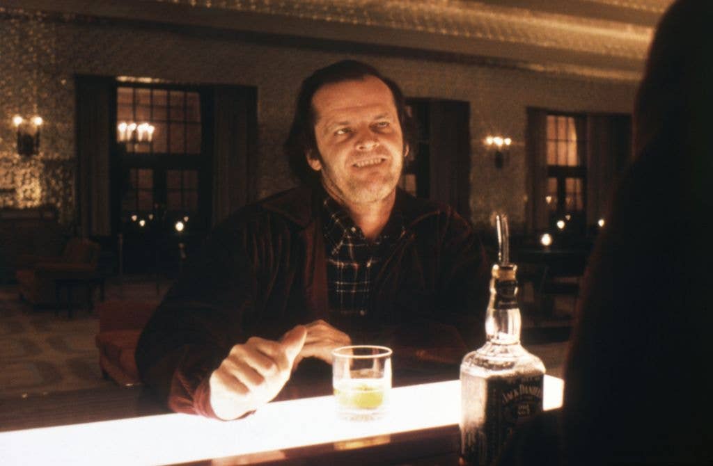 American actor Jack Nicholson on the set of The Shining, sat at a bar.