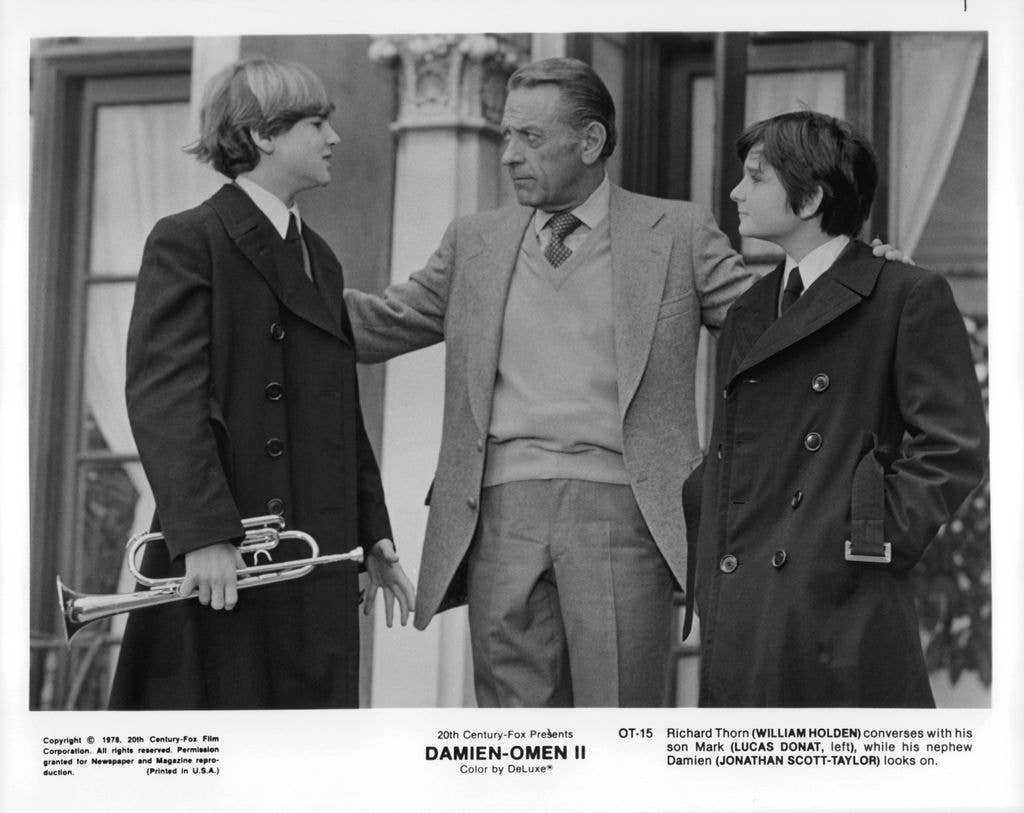 William Holden converses with his son Lucas Donat in a scene from the film 'Damien Omen II'.