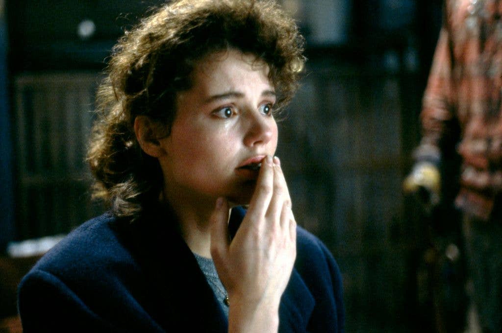 Geena Davis tears up on the set of 'The Fly', holding a hand lightly up to her mouth.
