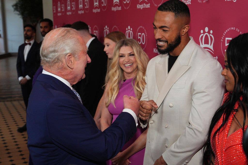 King Charles III receives a fist bump from Tyler West