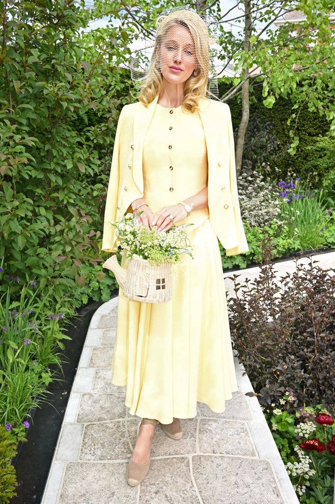 Leonora Smee wears a yellow midi dress and matching cardigan