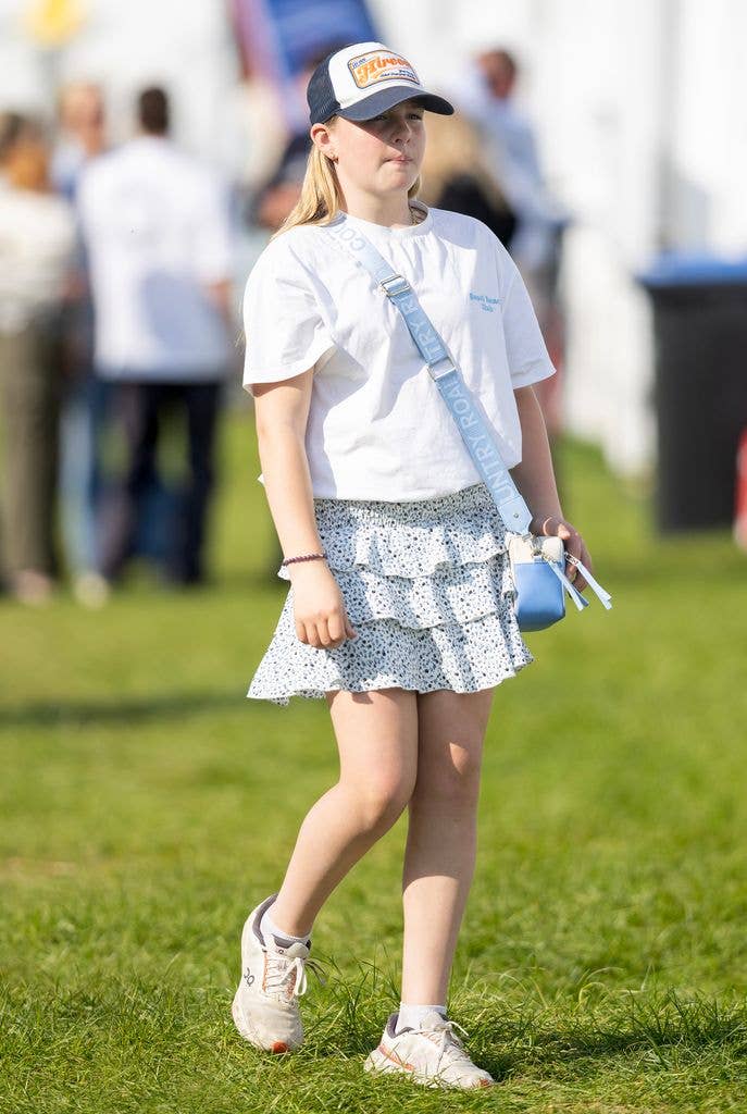 mia tindall in white t shirt and skirt in field