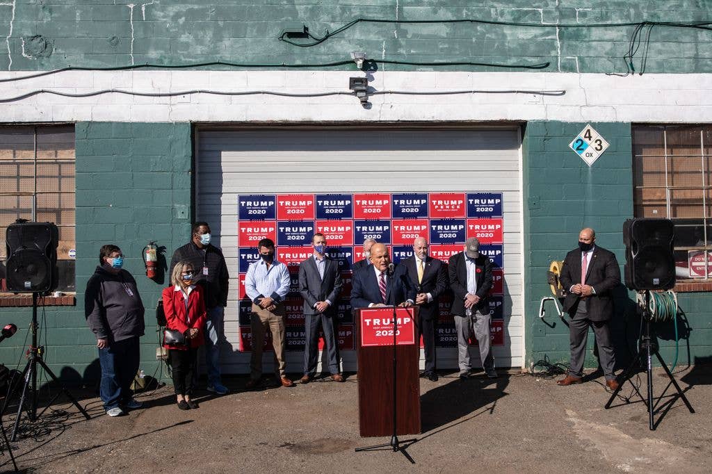 Rudy Giuliani speaks to the media at a press conference held in the back parking lot of Four Seasons Total Landscaping