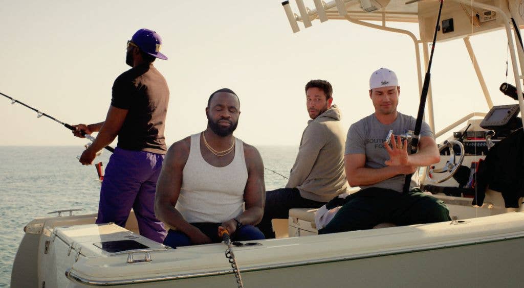Four men fishing on a boat