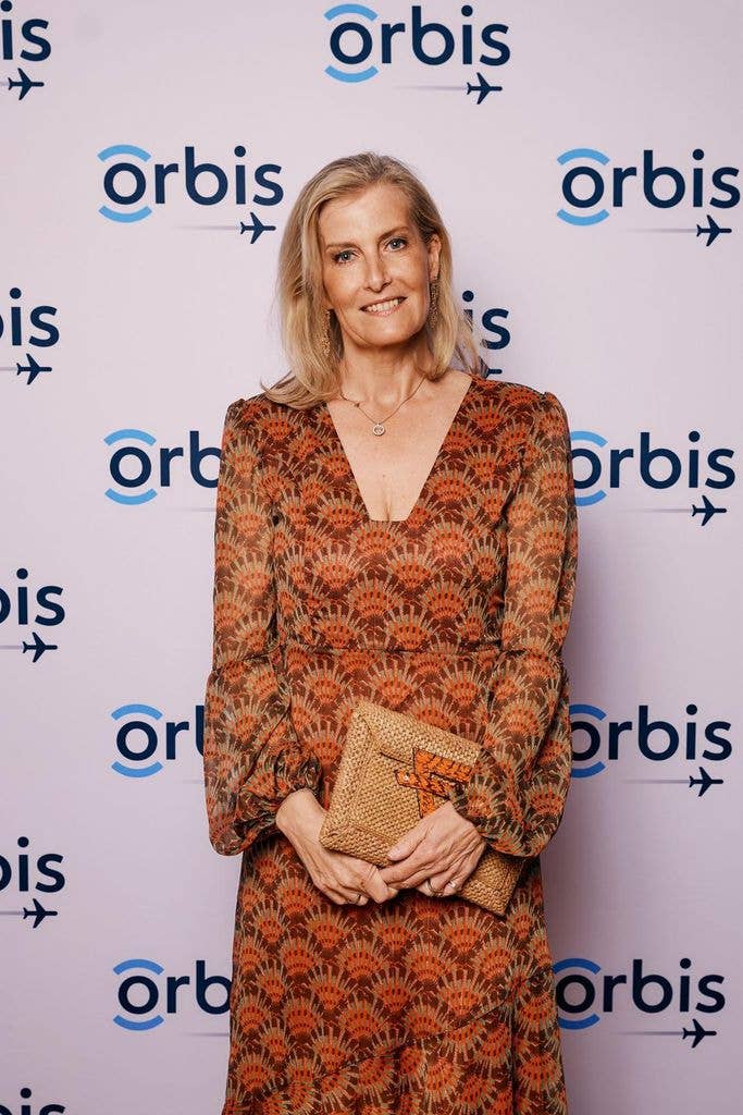 blonde woman in orange dress