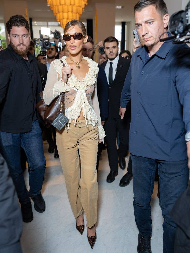 Bella Hadid wore a in sheer blouse and beige pants