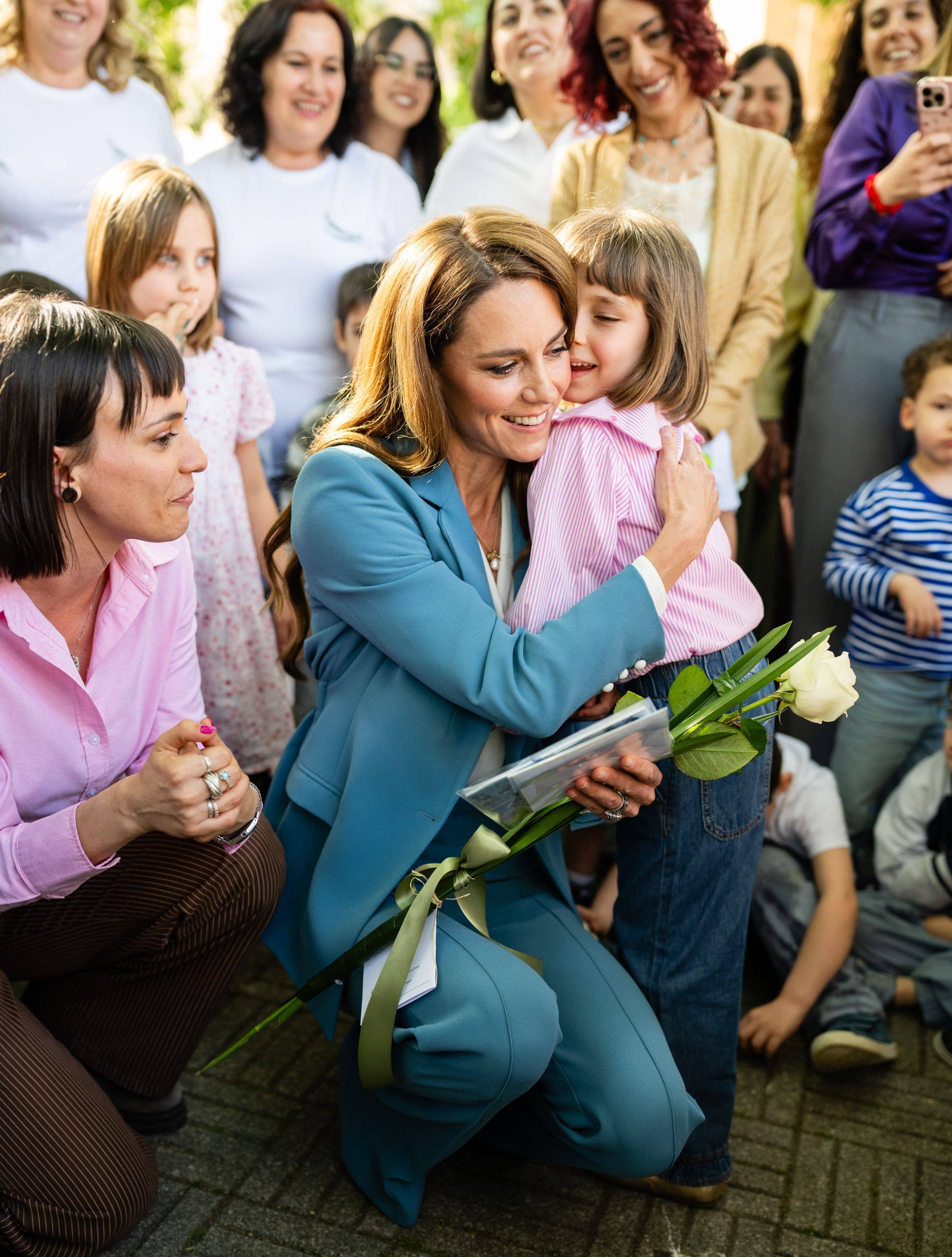 Kate Middleton huging an Italian child