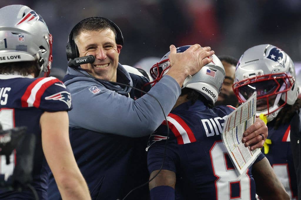 Mike Vrabel of the New England Patriots celebrates with Stefon Diggs #8 after a touchdown against the Houston Texans during the second quarter in the AFC Divisional Playoff game at Gillette Stadium on January 18, 2026 in Foxborough, Massachusetts