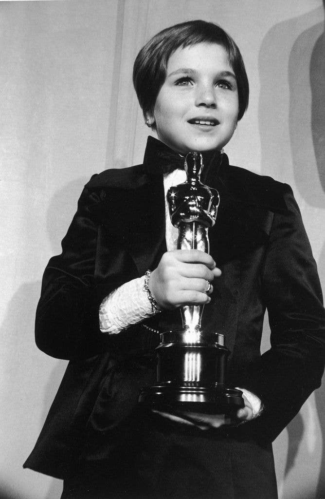 American actor Tatum O'Neal, wearing a tuxedo, holds her Oscar for Best Supporting Actress for her role in director Peter Bogdanovich's film, 'Paper Moon,' at the 1974 Academy Awards
