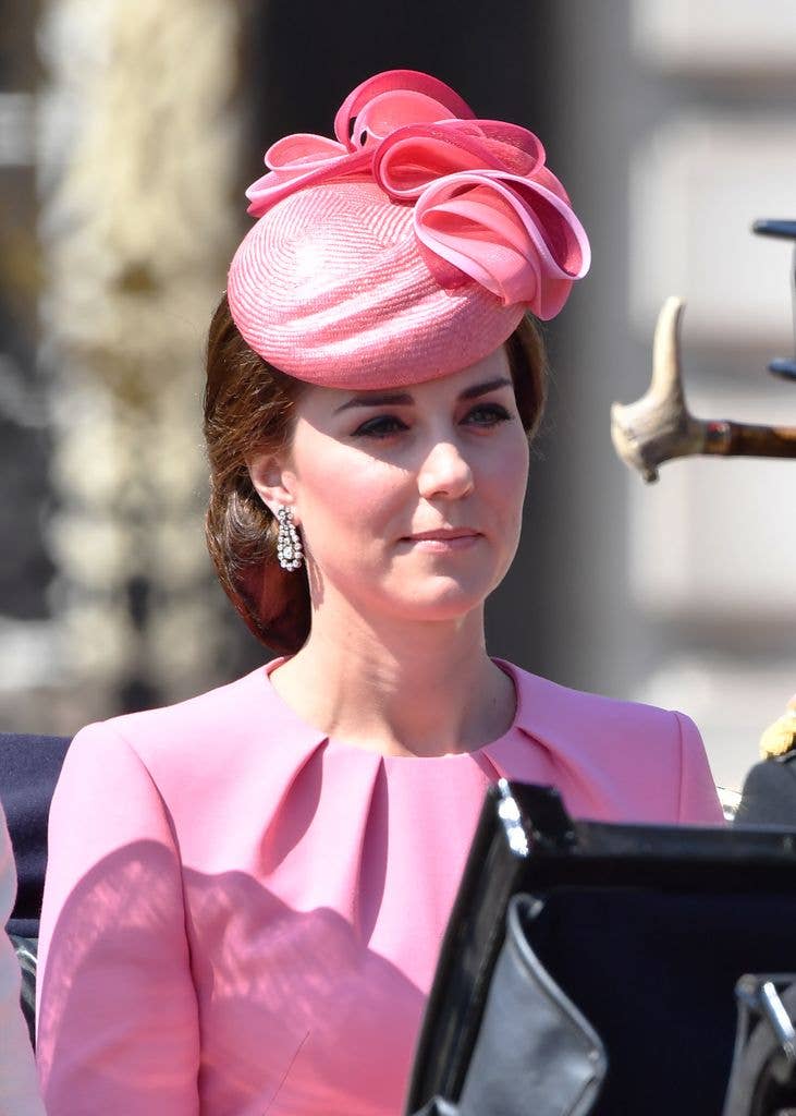 Catherine in an open carriage in bubblegum pink hat and dress