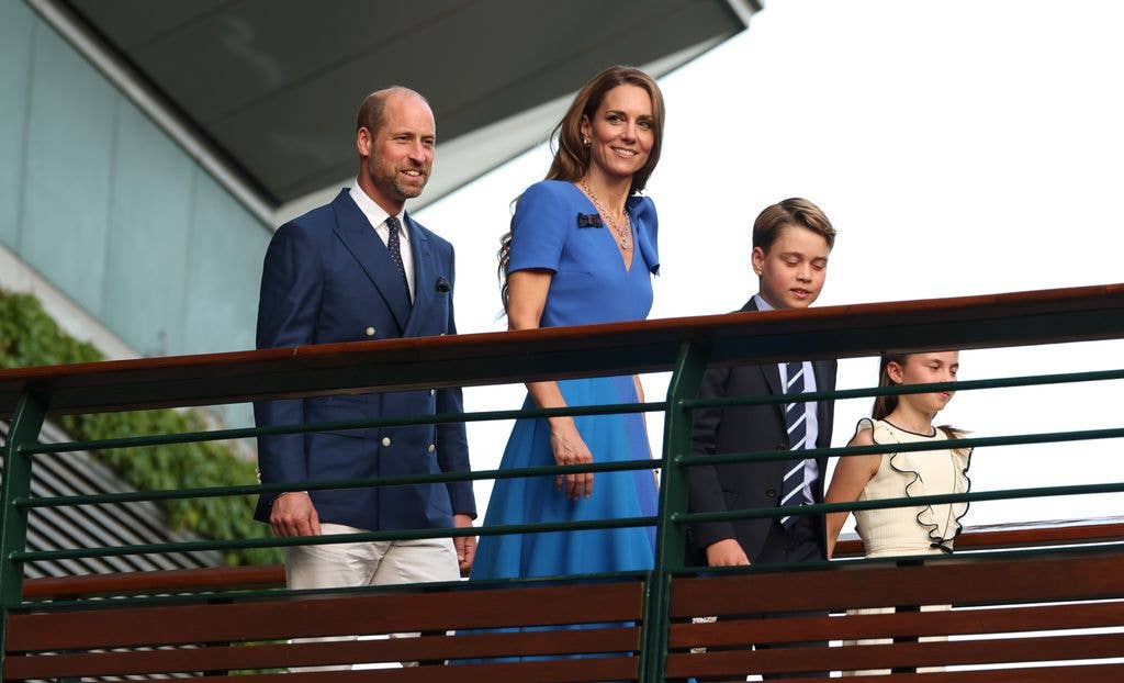 William, Kate, George and Charlotte cross the player's walkway bridge on day fourteen of The Championships Wimbledon 2025