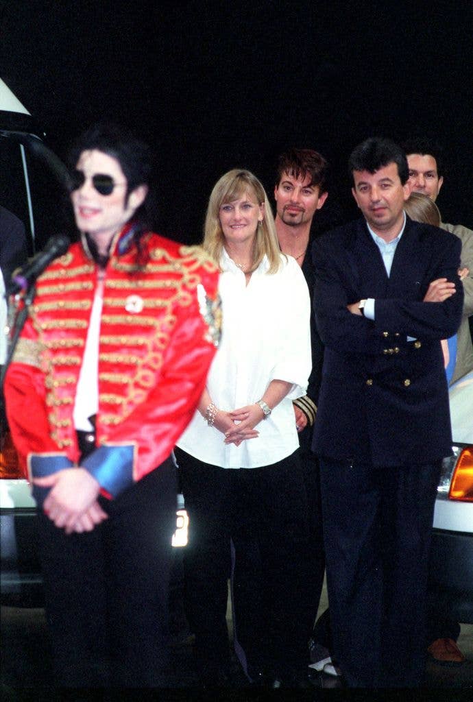 Michael Jackson signs autographs for fans as wife Debbie Rowe looks on, on July 10, 1997 in Sheffield, England
