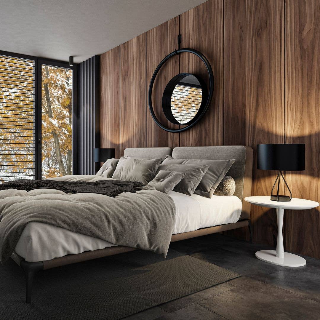 Modern bedroom with a large bed, wooden walls, and a view of autumn trees.