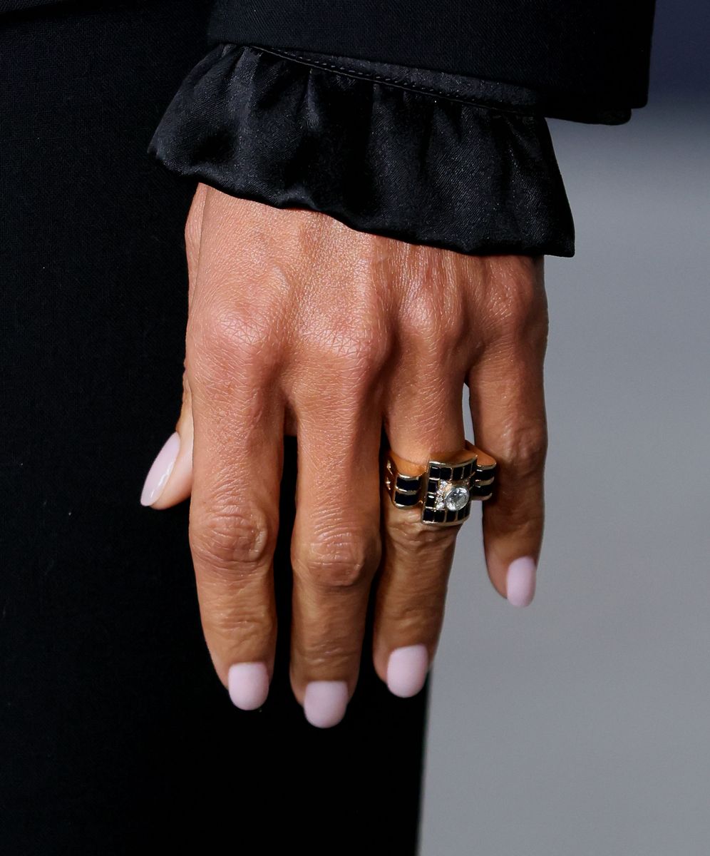 Her engagement ring shimmered under the flashbulbs, impossible to ignore.
