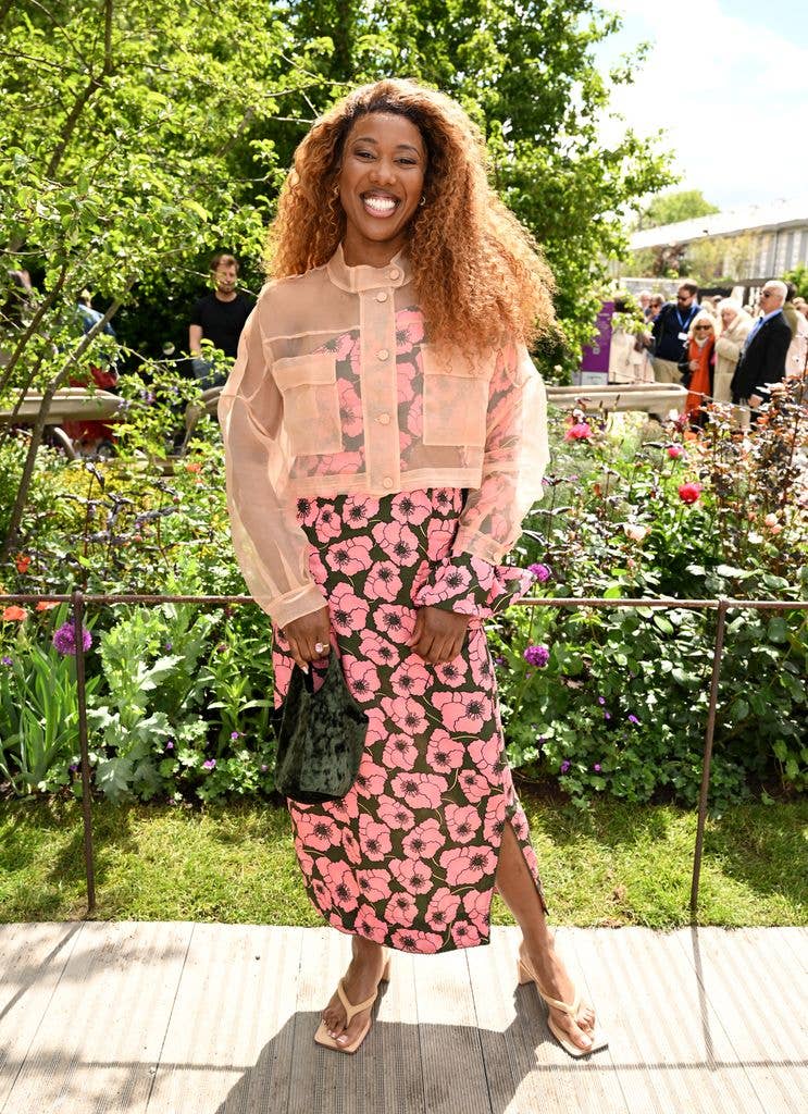 Montell Douglas wears a pink floral skirt and sheer pink jacket