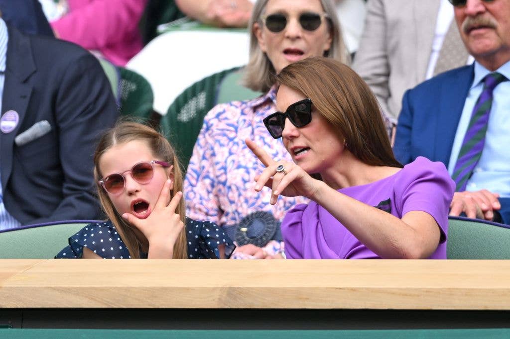 Princess Charlotte with her hand on her chin wearing sunglasses at Wimbledon
