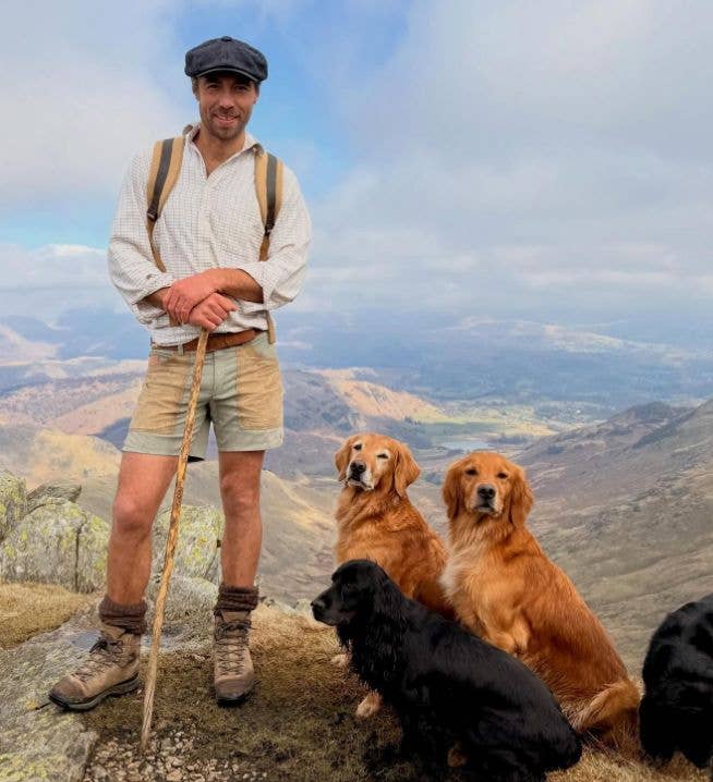 James Middleton on a mountain with four dogs