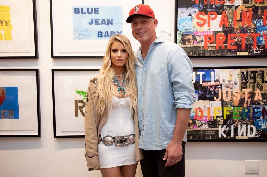 Jessica Simpson in white dress and trench and Eric Johnson in blue shirt and red cap