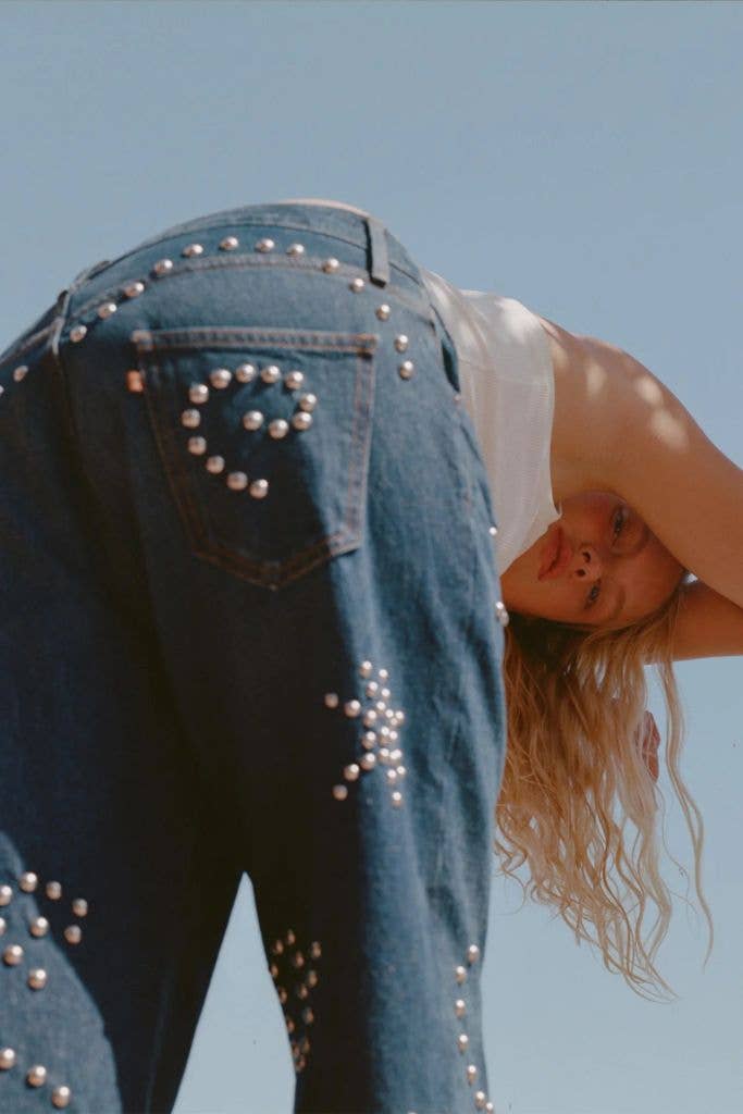 model in studded blue jeans