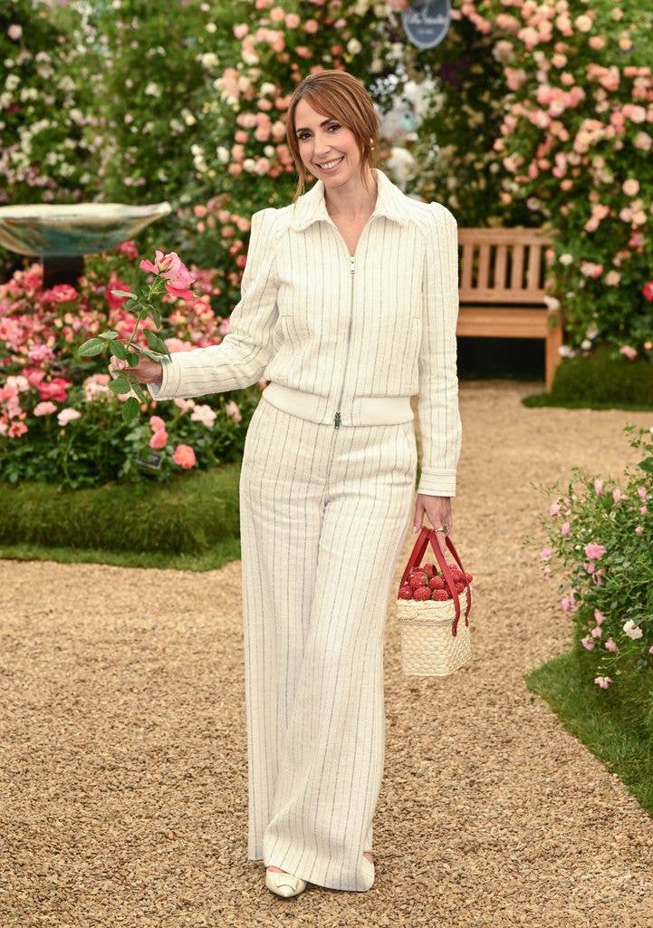 Alex Jones wears a pinstripe jacket and matching trousers