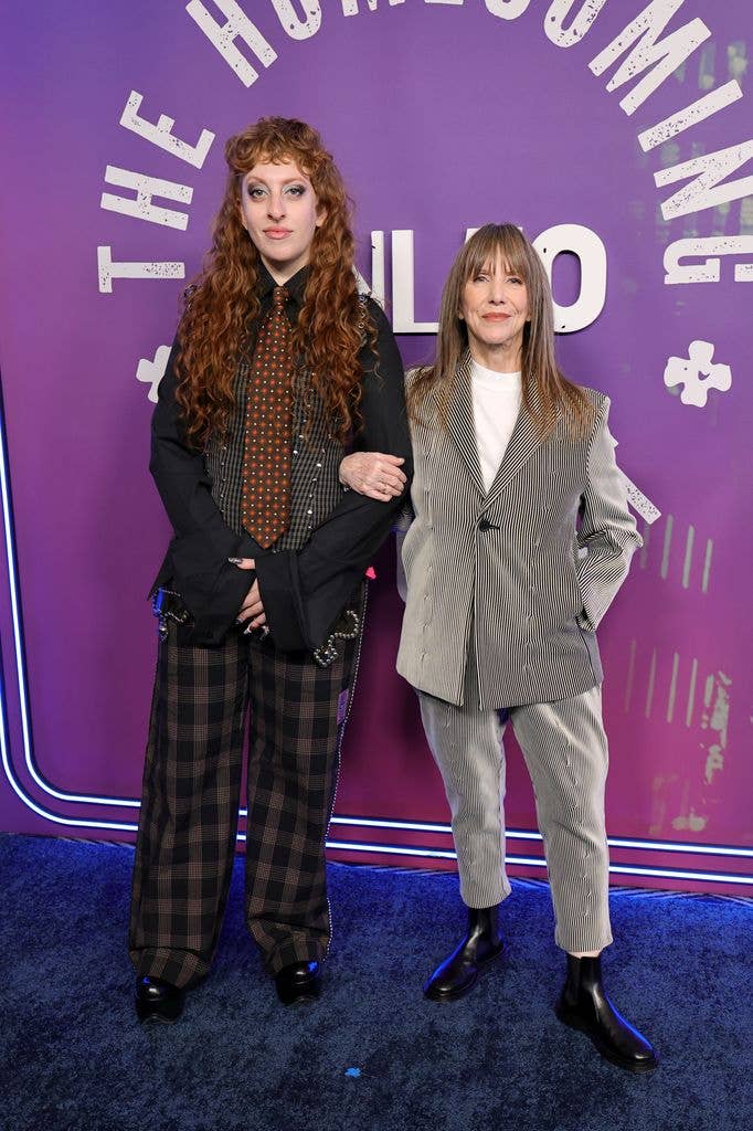 Spike Einbinder and Laraine Newman. Laraine wears a zebra print suit while Spike wears a dark suit, burgundy tie and black check trousers.